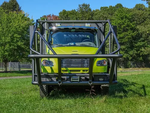 Head-on front view with grille and full protective bumper cage.