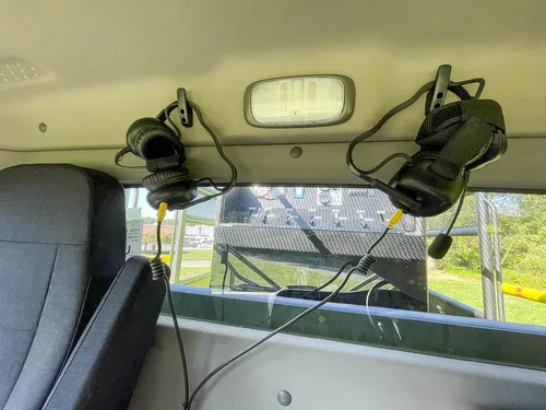 Rear interior wall with mounted communication headsets.