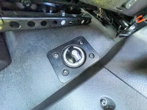 Ignition switch and lower console panel close-up.