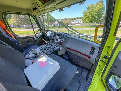 Passenger-side cabin view with gray seat and center console.