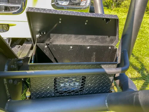 Open front bumper storage box beneath grille guard.