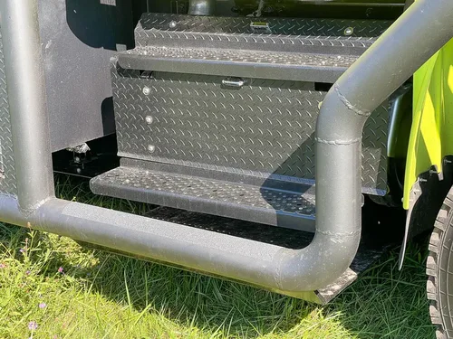 Close-up of passenger-side fold-out step and rail.