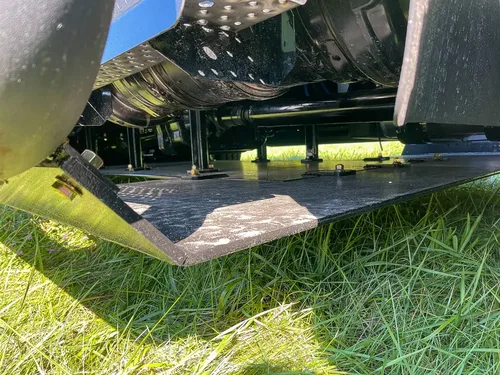 Underside step platform extended near front wheel.