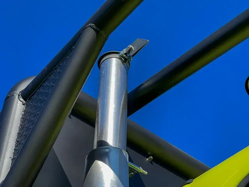 Vertical mast or pipe section against clear sky.