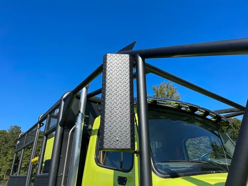 Upper brush cage upright post and roof light bar.
