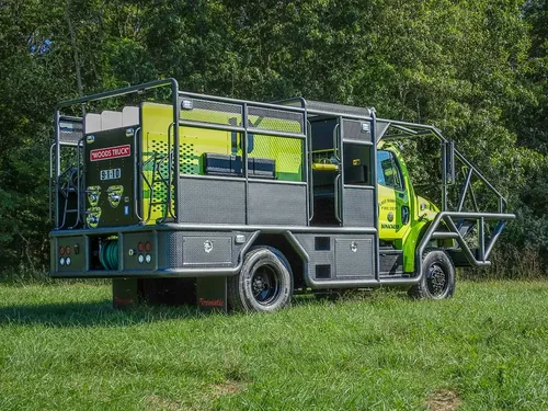 Rear driver-side angle showing side compartments and cage frame.