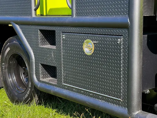 Closed side storage compartment doors with round latch knobs.