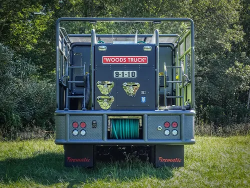 Straight rear view with hose reel opening and rear step.