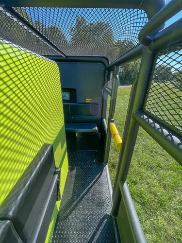 Open rear side access door along elevated walkway.