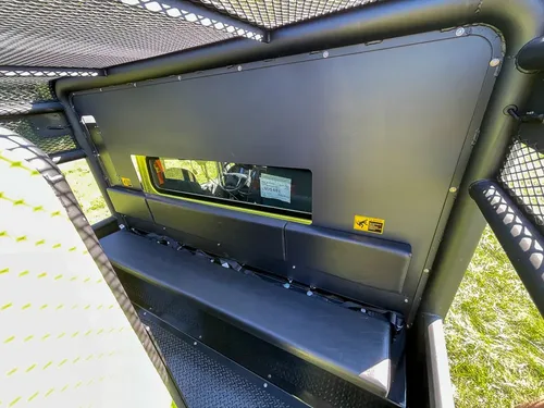 Open upper side compartment with narrow shelf and tools.