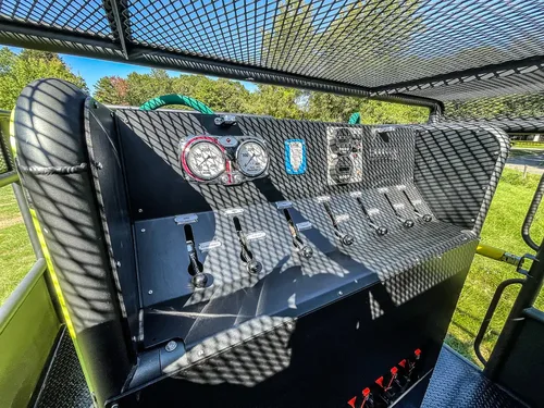 Rear pump control panel with gauges and lever controls.