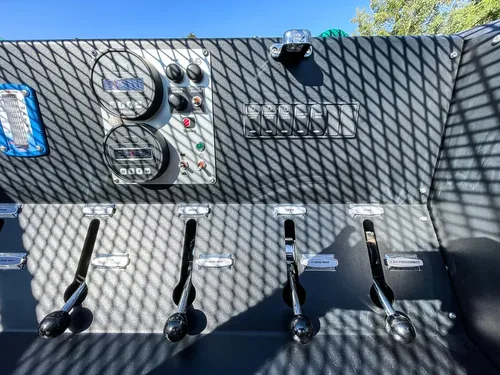 Control levers and couplings on rear pump panel.