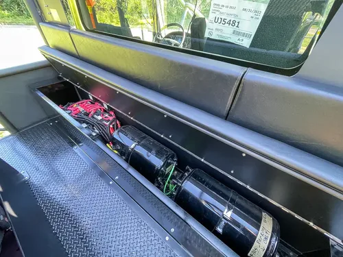 Open side shelf containing hose nozzles and fittings.