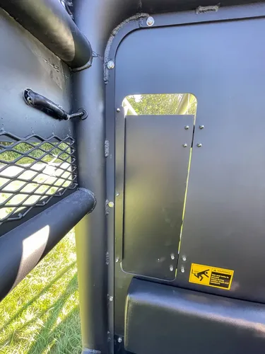 Tall narrow side cabinet door open on rear body corner.