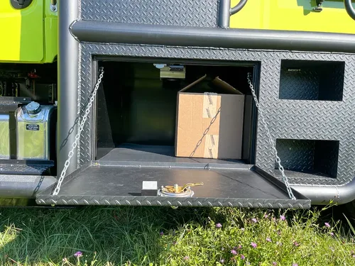 Open long lower compartment with cardboard box inside.