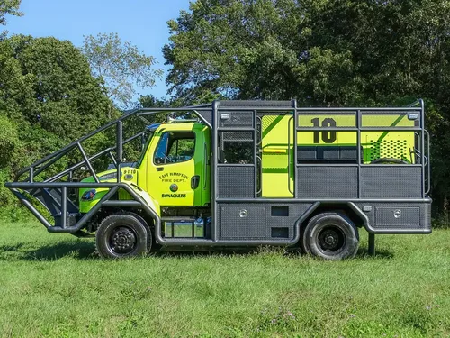 Full driver-side view with side compartments and cage rails.