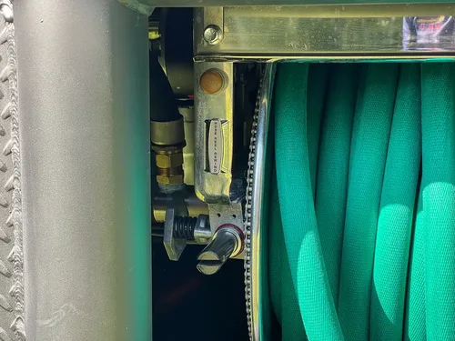 Side view of hose reel and pressure regulator hardware.