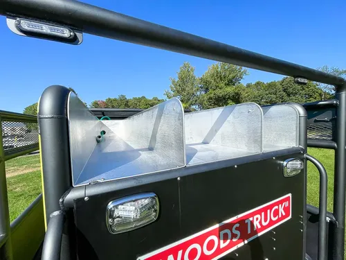 Open top trough or tank channel along rear deck side.