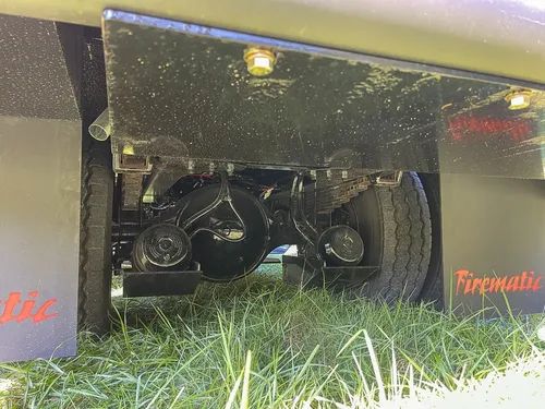 Underbody pump components visible from low rear side angle.