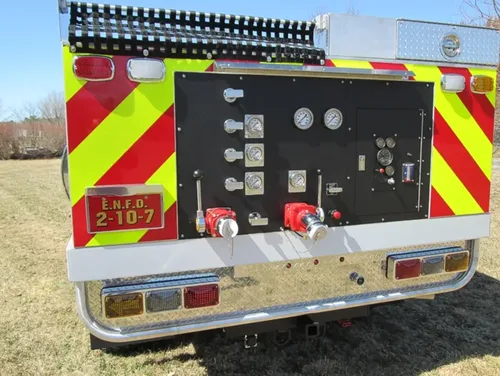 Exterior view of small fire truck showing cab, body compartments, and wheel/tire area.