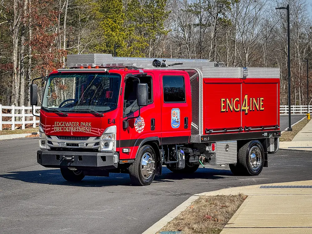 Front-left three-quarter exterior view of the red brush truck.