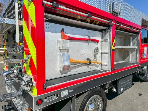 Open side compartment with tools mounted on the door panel.