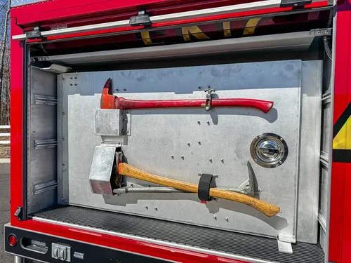 Compartment close-up showing axe and pry tool mounts.