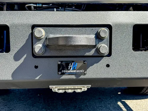 Front bumper close-up with recessed winch fairlead opening.