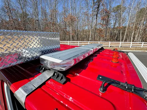 Top body rail close-up with folded ladder and red deck panel.