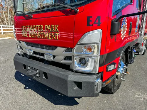 Front-left corner close-up with grille, bumper, and side stripe.