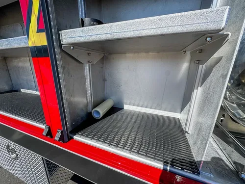 Open side compartment with fold-down door and empty shelf space.