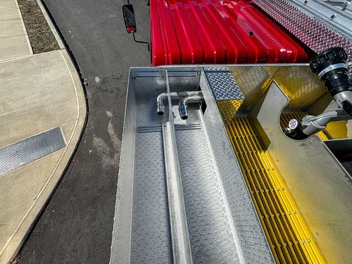 Top walkway view with mounted deck gun and red hose cover.