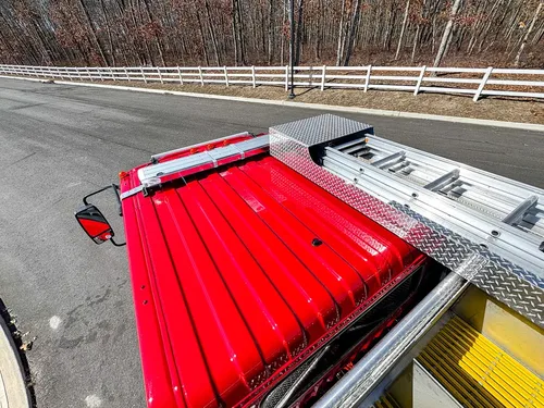 Rear upper deck with red hose cover and side rail visible.