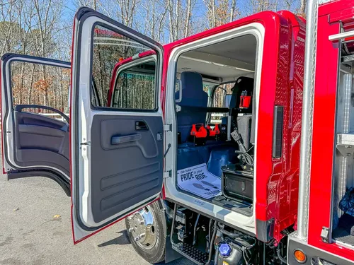 Open rear side door view showing bench area and interior layout.