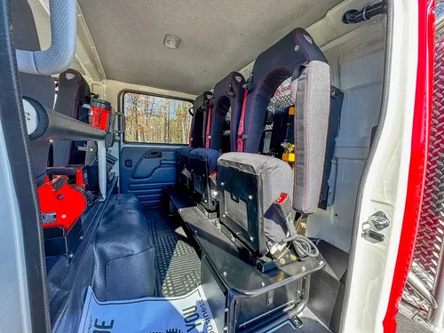 Rear seating area with center aisle and safety-seat backs visible.