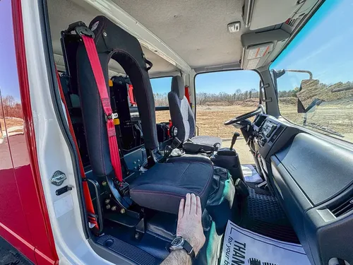 Passenger-side interior with rear seatback and center aisle.