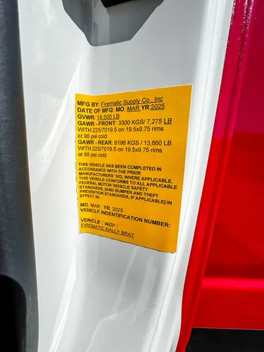 Close-up of yellow compliance sticker on the cab pillar.