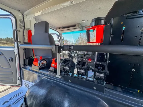Wide rear cabin view with control modules and mounted equipment.
