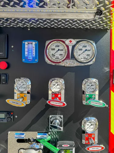 Pump panel center close-up with pressure gauges and valve controls.