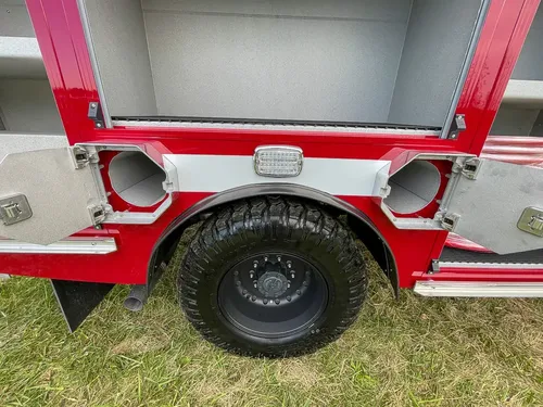 Passenger-side rear wheel and compartment area close-up.