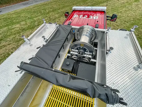 Top deck with black cover partially over rear hose reel.