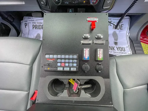 Rear console close-up with cup holder and accessory panel.