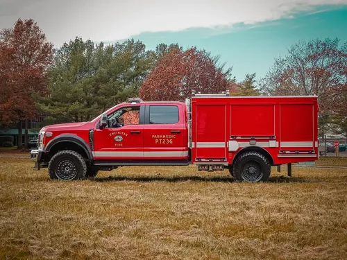 Full driver-side profile of truck parked on grass.