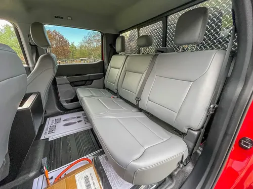 Rear bench seat and cabin floor area from open rear door.