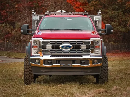 Head-on front view with grille guard and roof lights.