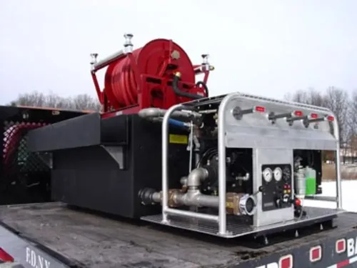 Exterior view of small fire truck showing cab, body compartments, and wheel/tire area.
