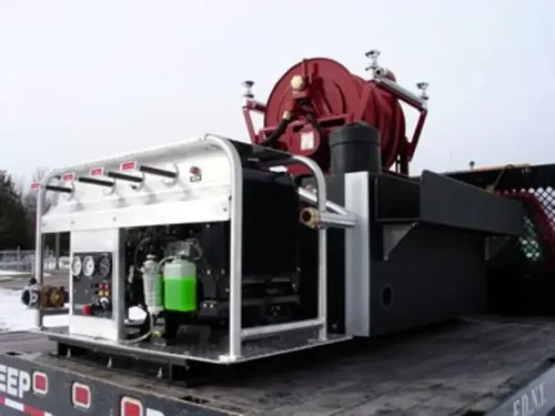 Exterior view of small fire truck showing cab, body compartments, and wheel/tire area.