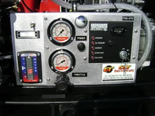 Exterior view of small fire truck showing cab, body compartments, and wheel/tire area.