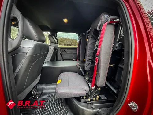 Open rear door view with side seat and mounted equipment bracket.