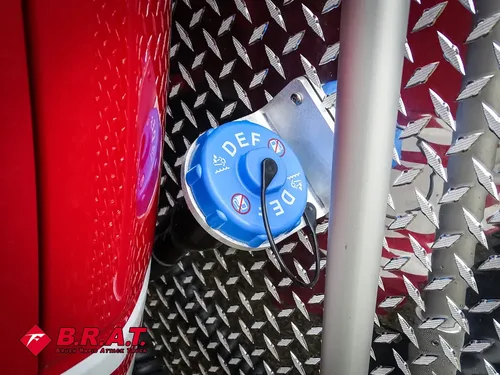 Blue DEF cap close-up on diamond-plate side panel.